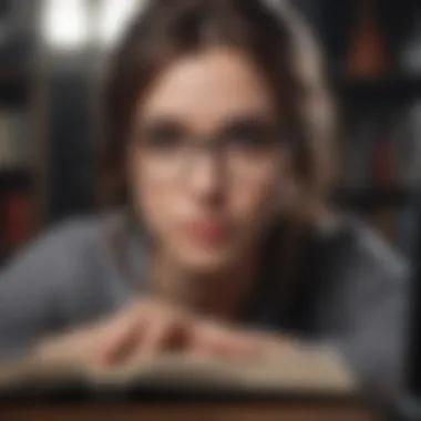 Close-up of a student studying with books and a laptop